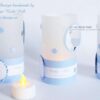 Windlichthüllen Tischlicht-Hüllen für Teelichter mit Foto vom Baby. Auf dem unteren Papierstreifen in blau, ist ein personalisierter Text gedruckt und daneben auf einem karierten Hintergrund süße Babyfüsschen geprägt. Handgefertigt aus 115g Transparentpapier. Hüllen mit gestanzten Sternen. In vielen Farben im Karten-Shop erhältlich. © KARTEN-DESIGN.at
